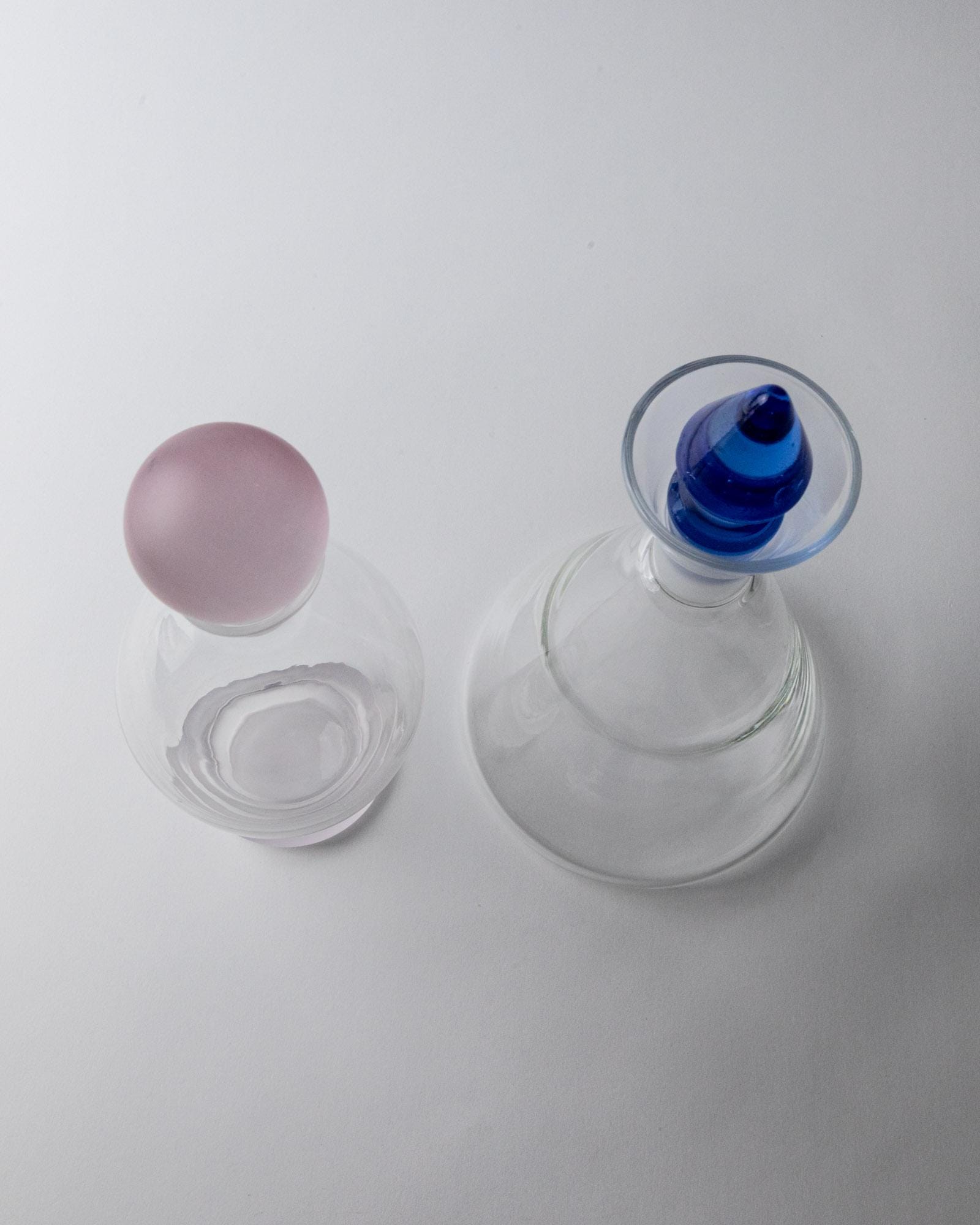 Vintage 1980s Glass Decanter Set of 2, Clear Glass with pink, blue Stoppers, Different Sculptural Shapes, Bar Accessory, Elegant Gift Idea_Bottega Jacobs