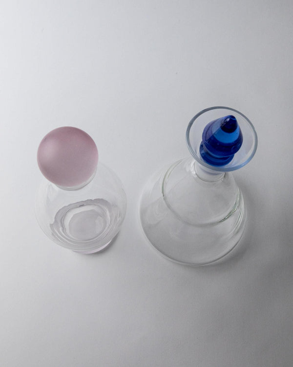 Vintage 1980s Glass Decanter Set of 2, Clear Glass with pink, blue Stoppers, Different Sculptural Shapes, Bar Accessory, Elegant Gift Idea_Bottega Jacobs
