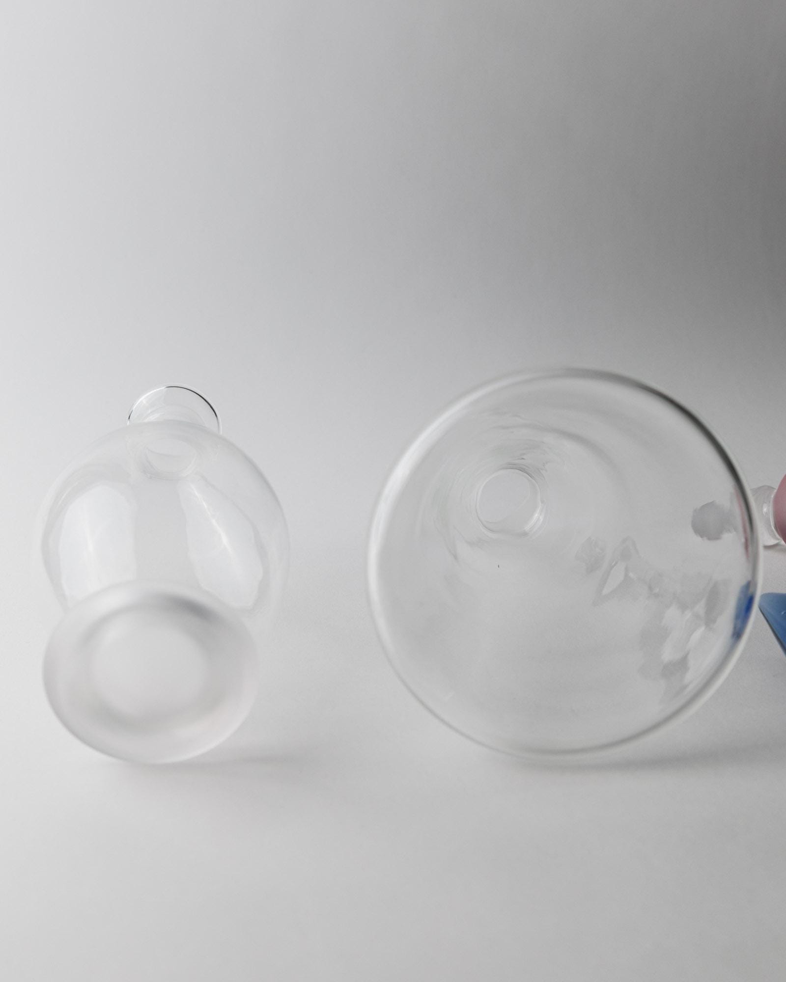 Vintage 1980s Glass Decanter Set of 2, Clear Glass with pink, blue Stoppers, Different Sculptural Shapes, Bar Accessory, Elegant Gift Idea_Bottega Jacobs